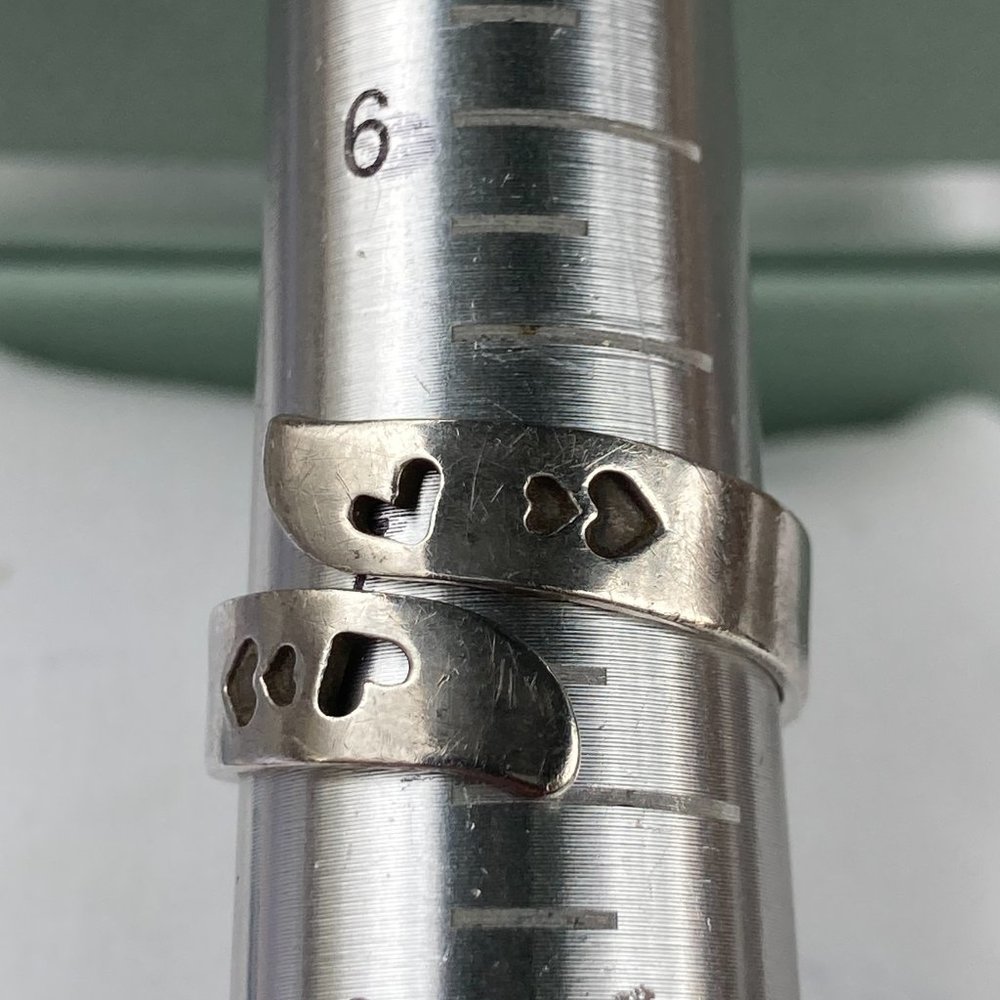 Sterling silver by-pass ring with hearts on outside and "you are loved" inside